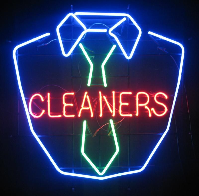 Neon sign in the shape of a shirt and tie, saying 'Cleaners'